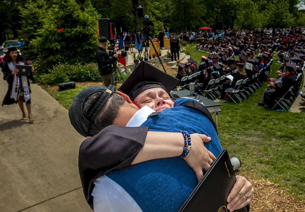 Sadie Tristam ’17 embraces her dad after coming off the commencement stage. 