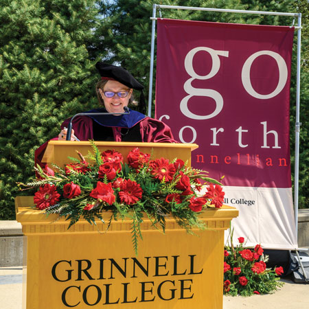 Ann Harris at the podium at virtual commencement