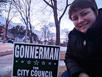 Erin Gonnerman poses by one of her campaign signs