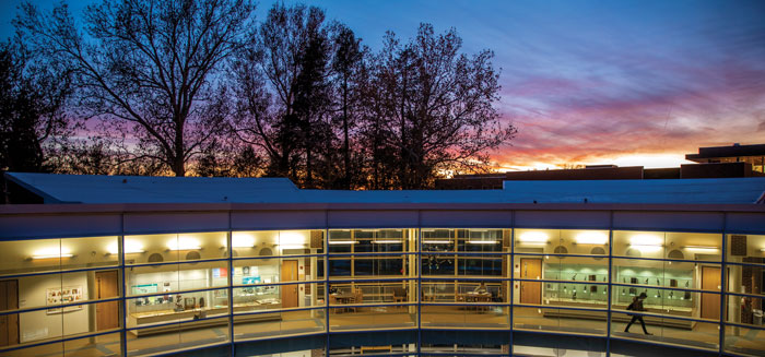 The Noyce Sience Center elbow light up at sunset