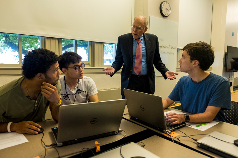 Visiting professor Ron Rapoport leads a discussion with students Max Hill ’20, Yuejun Chen ’20, and Patrick Min ’19 (left to right).
