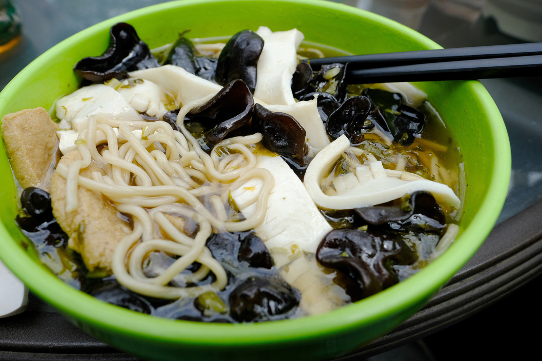 Vegetarian dish with tofu, mushroom, and noodles