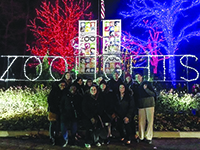 Image of group in front of zoo lights