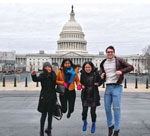 People jump with U.S. Capitol in the background