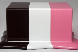 A glossy rectangular box with three stripes of color - brown, cream, and pink - that puddle at the base