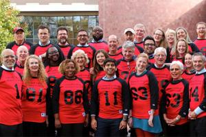 Alumni Council members pose in old Grinnell sports jerseys