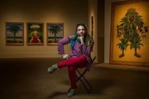 Fredo Rivera ’06 sitting on a chair in the Faulconer Art Gallery