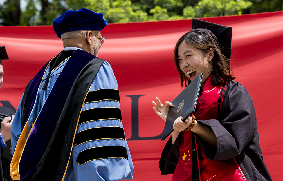 Xiaoxuan (Jessie) Yang ’17 accepts her diploma from President Raynard S. Kington.