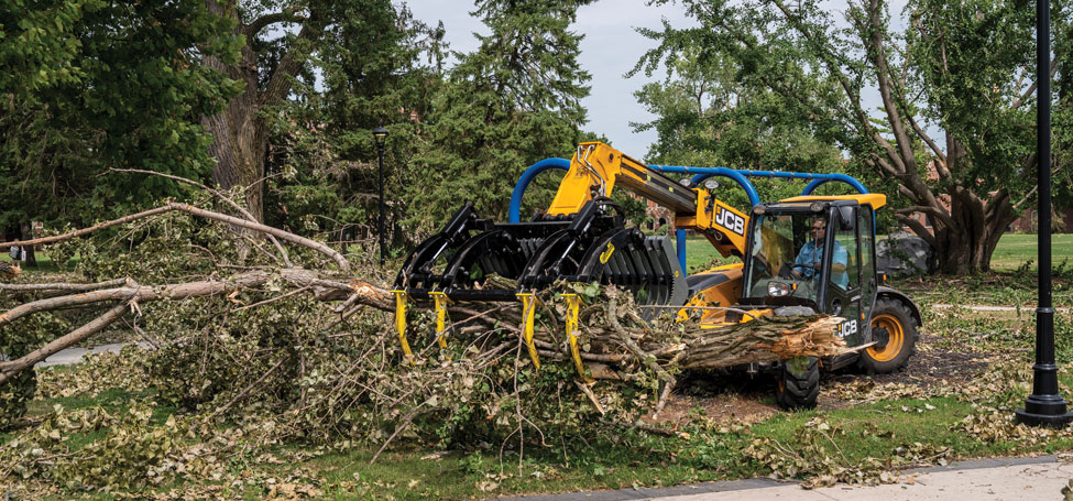 Large machinery in use to gather and move brush piles 