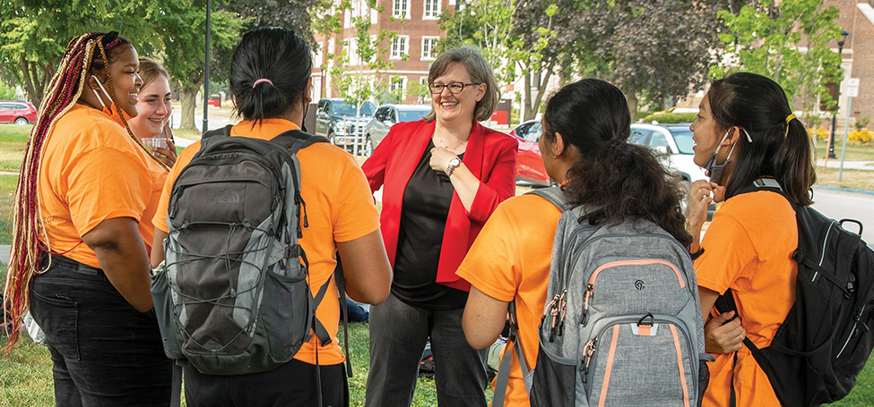 Students talking with President Anne Harris at beginning of year