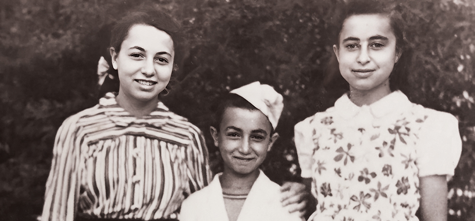 Harold Kasimow with his sisters Rita and Miriam. Harold wears a smart hat and one sister wears a striped shirt with a bow in her hair, the other a floral dress