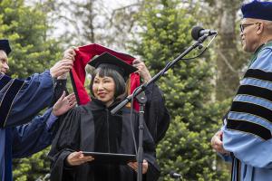 Amy Tan being hooded
