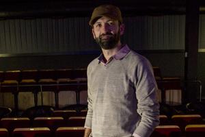 Andrew Sherbourne '01 shown in the theater at Film Scene in Iowa City
