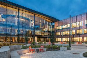 Humanities and Social Sciences Center and courtyard lit up at dusk 