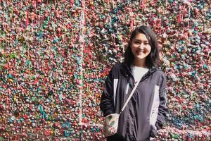 Michi Soderberg ’21 stands in front of bubble gum wall