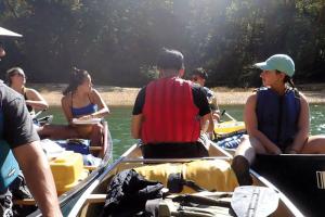 6 students paired in laden canoes
